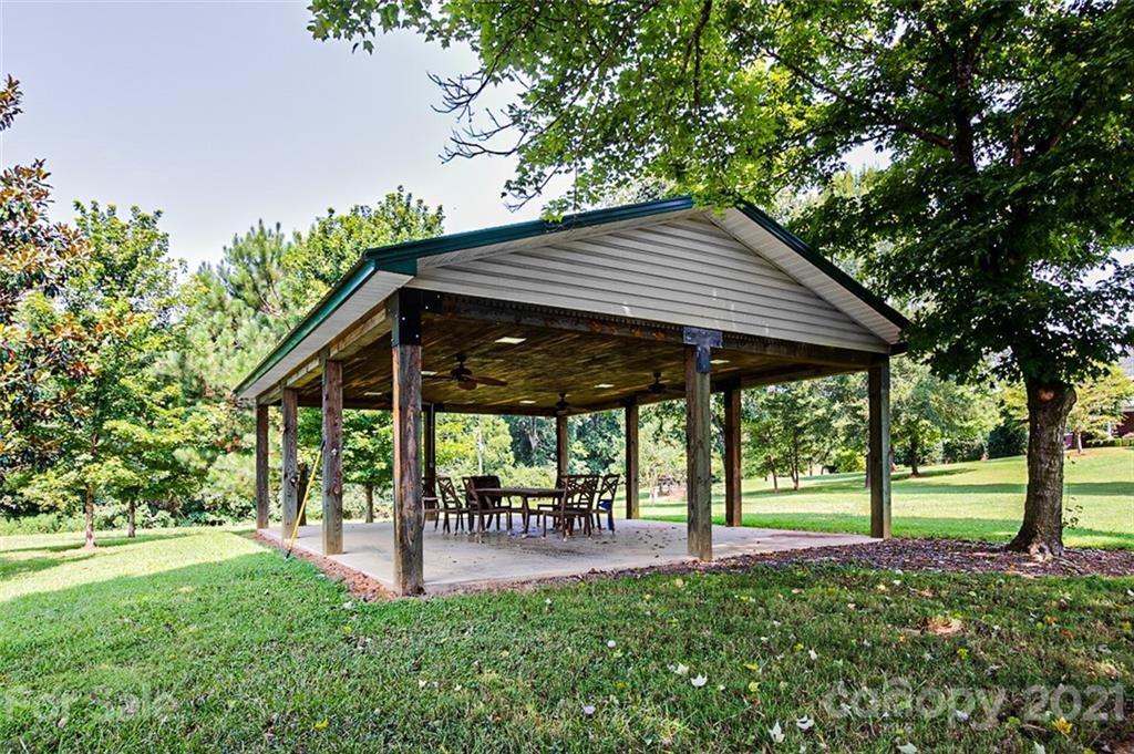 2215 Old Lexington Road Asheboro, NC 27205 - Photo 43 of 48 a view of a patio with table and chairs under an umbrella