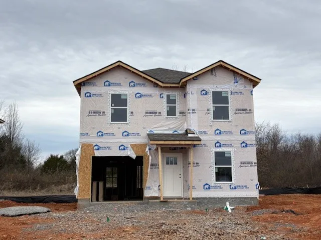 a view of a house with a yard and garage