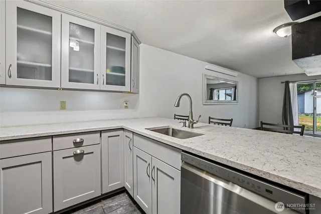 a kitchen with a sink and a mirror