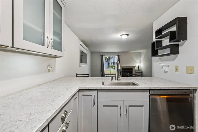 a kitchen with stainless steel appliances granite countertop white cabinets and stove