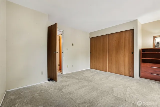 a view of a hallway with a chandelier fan
