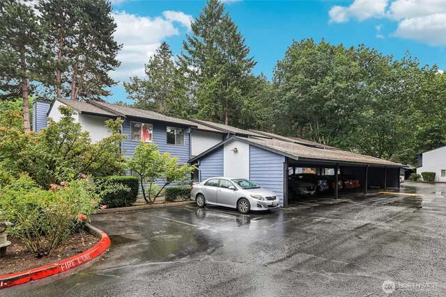 a view of a house with a yard and sitting area