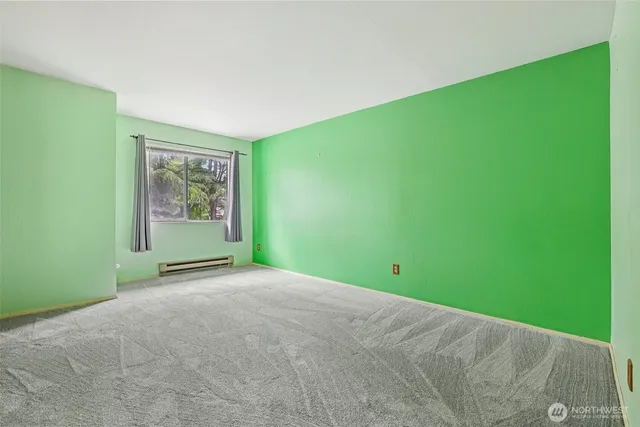 a bedroom with a bed and a painting on the wall