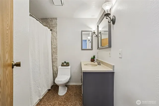 a bathroom with a sink vanity and mirror
