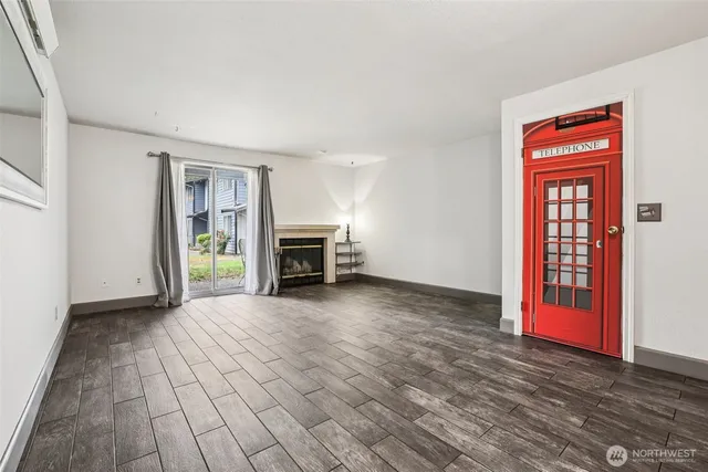 a view of livingroom with hardwood floor and a fireplace