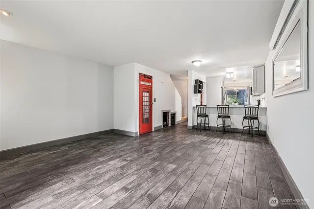 a view of a livingroom with wooden floor and stairs