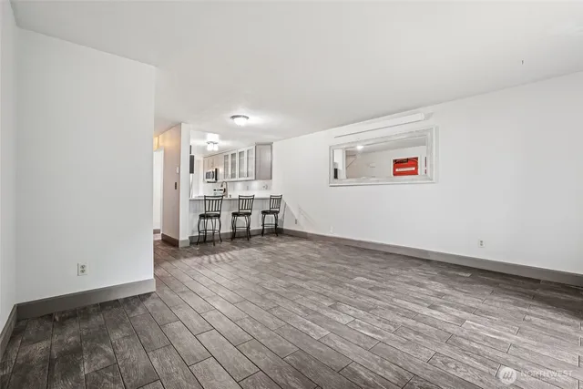 a view of a kitchen with wooden floor and a window