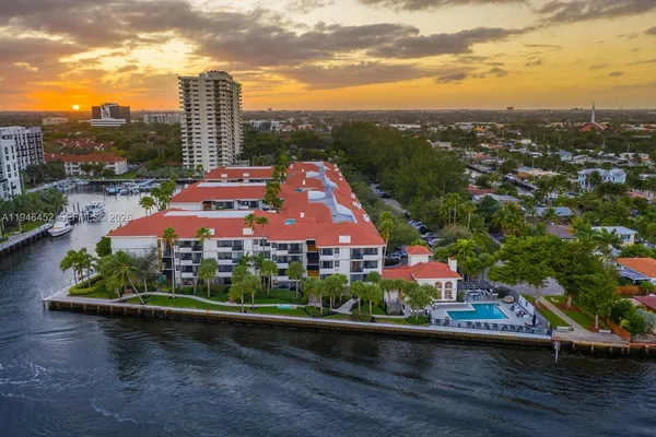 an aerial view of a house with a garden and lake view