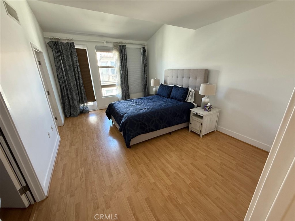550 South Brea Boulevard Brea, CA 92821 - Photo 13 of 17 a spacious bedroom with a bed and wooden floor
