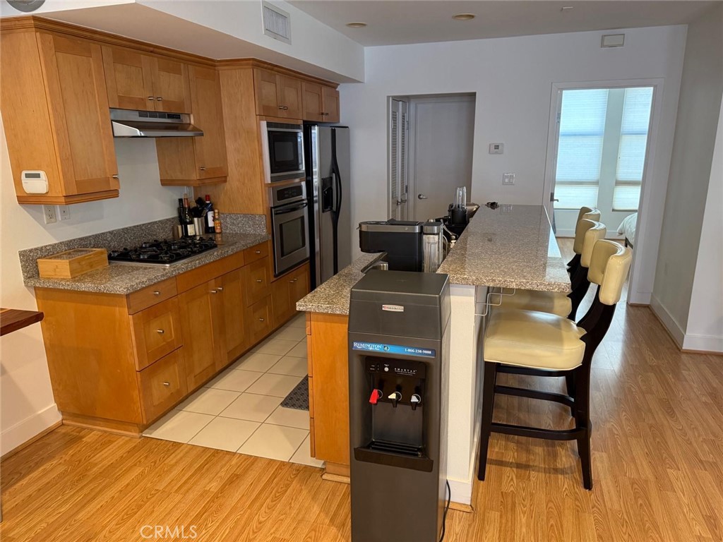 550 South Brea Boulevard Brea, CA 92821 - Photo 5 of 17 a kitchen with a sink stove and refrigerator