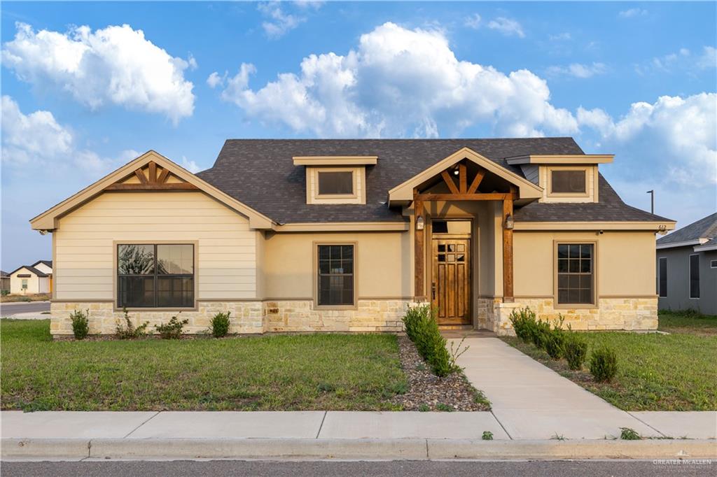a front view of a house with a yard