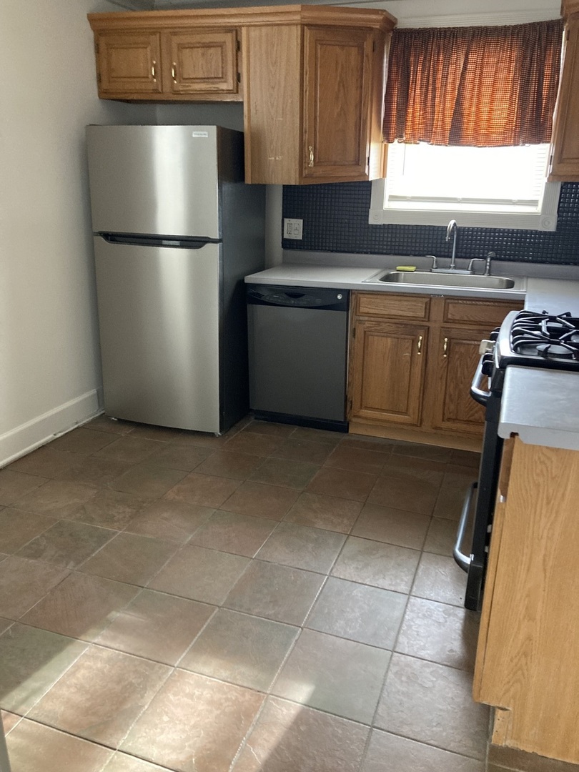2155 Spruce Road Homewood, IL 60430 - Photo 11 of 18 a kitchen with stainless steel appliances granite countertop a refrigerator sink and window