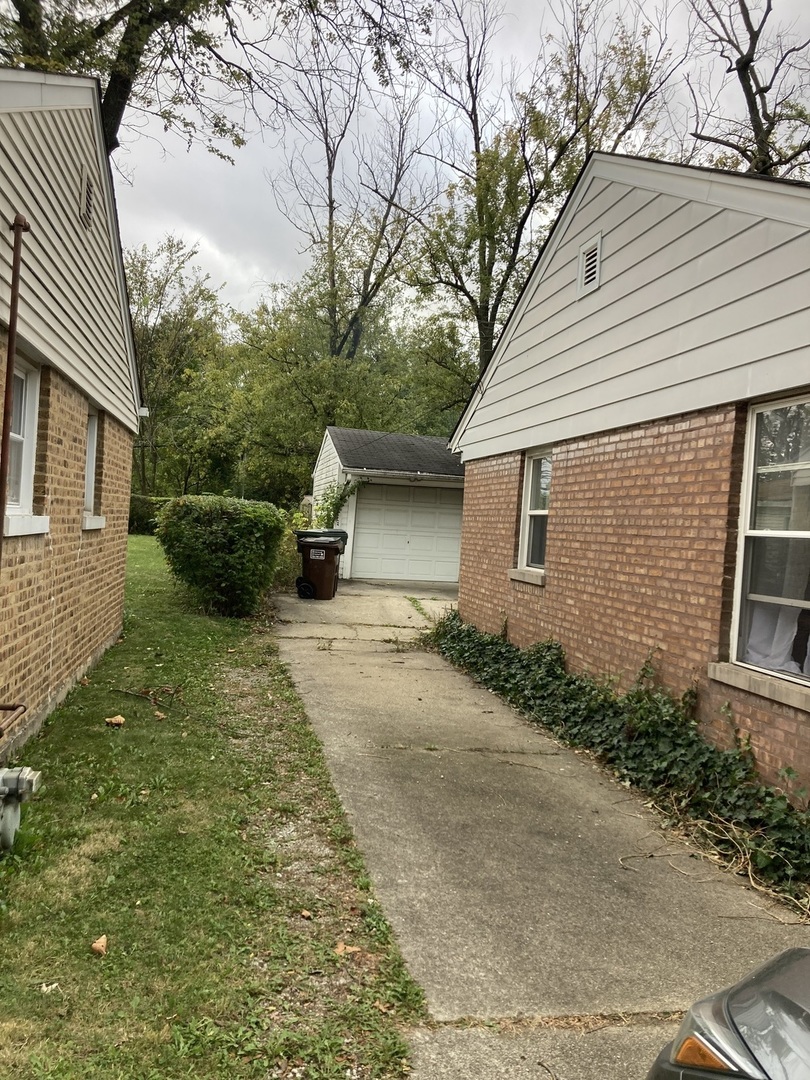 2155 Spruce Road Homewood, IL 60430 - Photo 17 of 18 a backyard of a house with potted plants and large tree