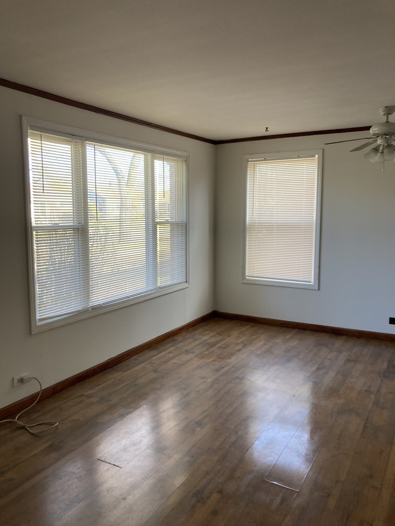 2155 Spruce Road Homewood, IL 60430 - Photo 4 of 18 an empty room with wooden floor and windows
