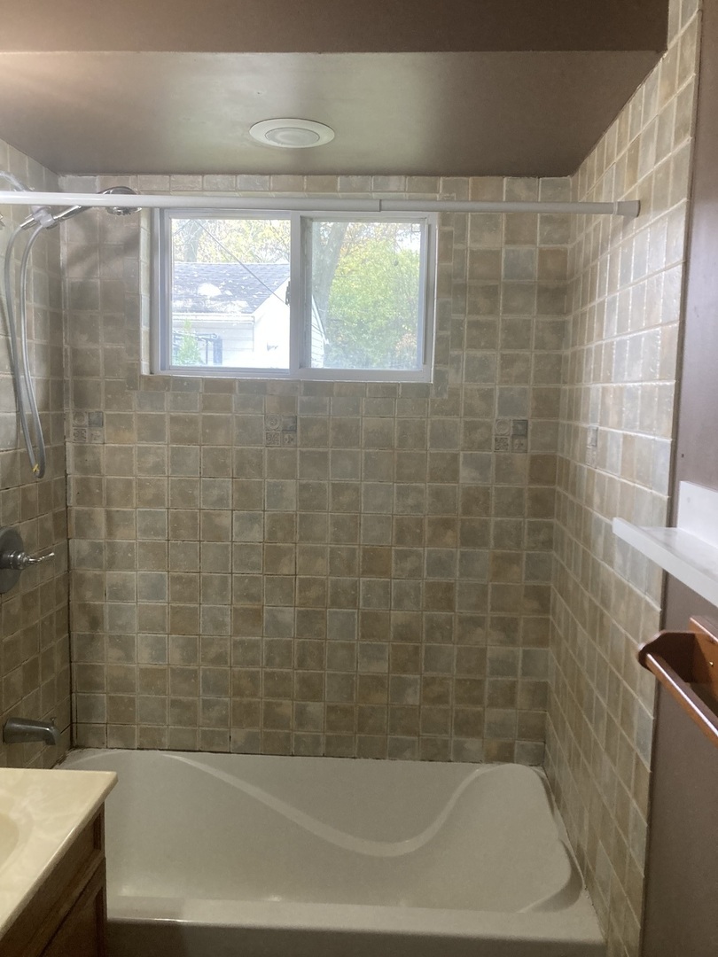 2155 Spruce Road Homewood, IL 60430 - Photo 10 of 18 a bathroom with a bathtub and a shower