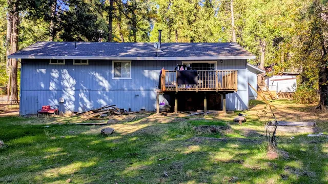 a view of a backyard with table and chairs and potted plants