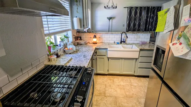 a bathroom with a sink a mirror and next to a window