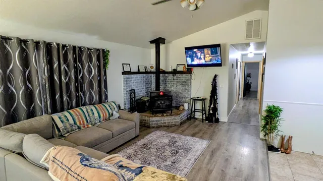 a living room with furniture a ceiling fan and a rug
