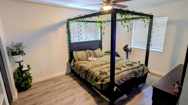 a bedroom with a bed and a potted plant