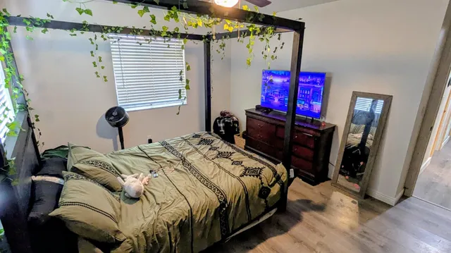 a bedroom with a bed and a mirror