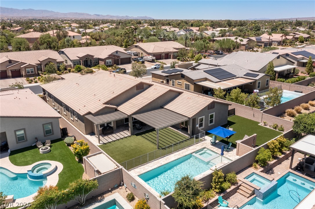 7036 Arabian Ridge Street Las Vegas, NV 89131 - Photo 8 of 64 Aerial view of this single story on its sprawling lot with plenty of covered patio and pergola space to help keep cool on those hot summer days and a sparkling pool and spa!