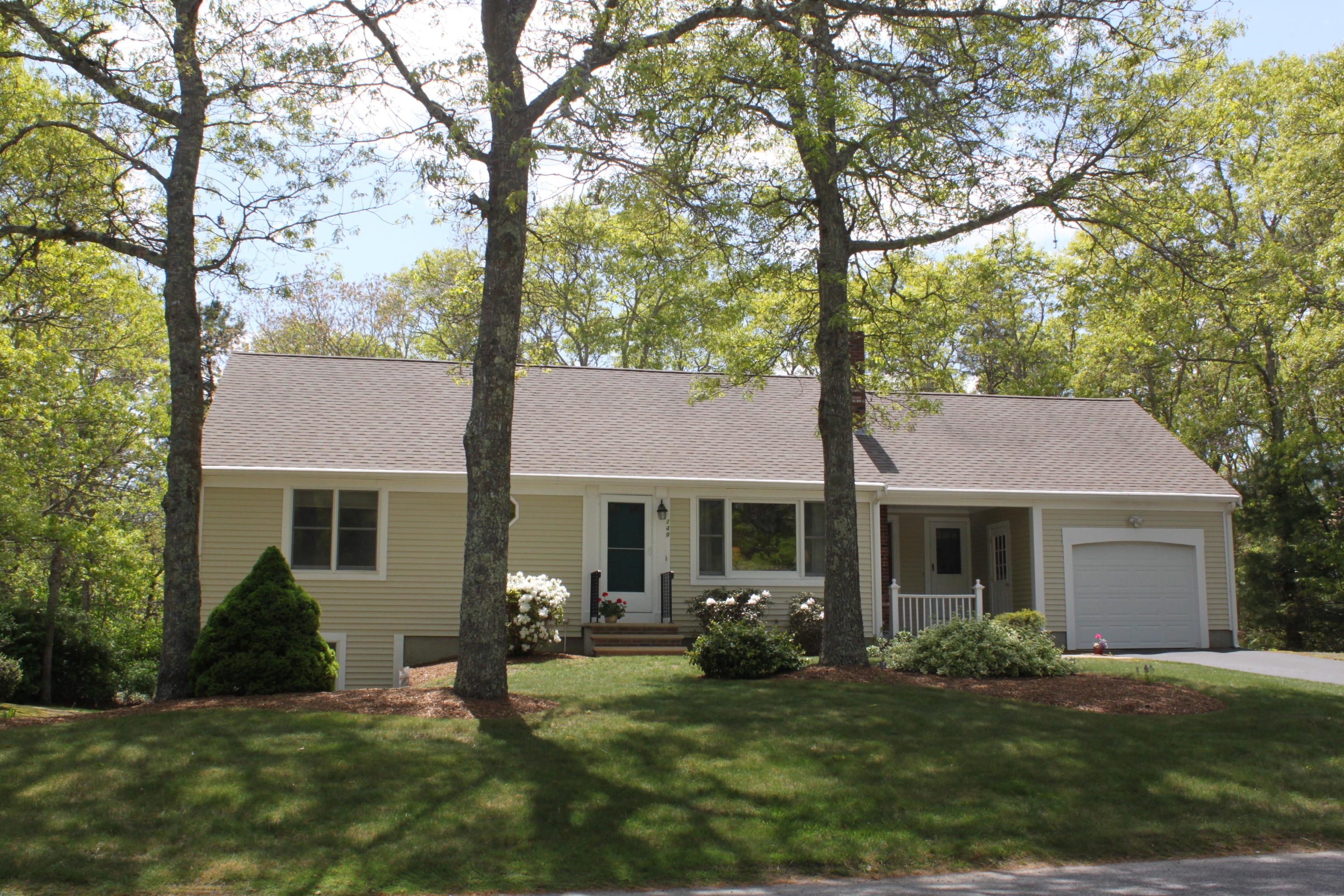 149 Camelback Road Marstons Mills, MA 02648 - Photo 1 of 25 a front view of a house with a yard and trees