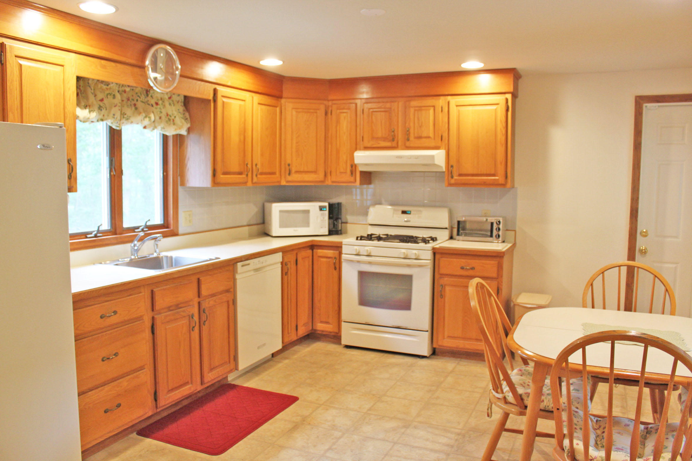 149 Camelback Road Marstons Mills, MA 02648 - Photo 5 of 25 a kitchen with a stove a sink and a refrigerator