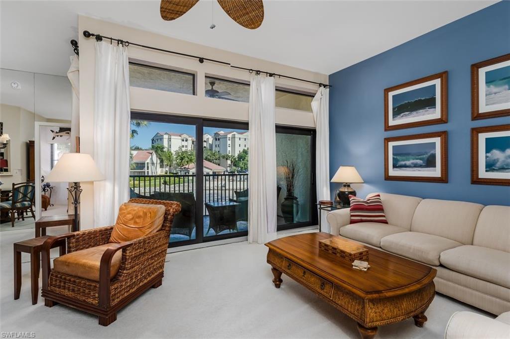a living room with furniture and a floor to ceiling window