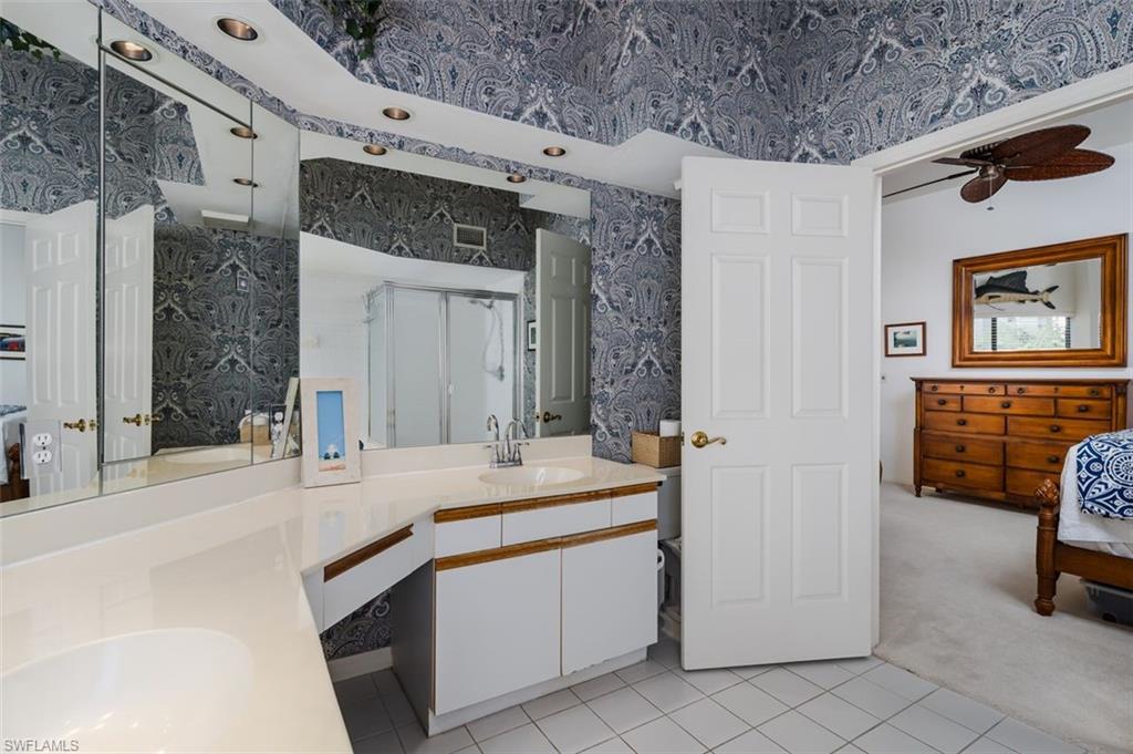 6545 Valen Way, Unit F205 Naples, FL 34108 - Photo 14 of 40 a bathroom with a sink double vanity and a mirror