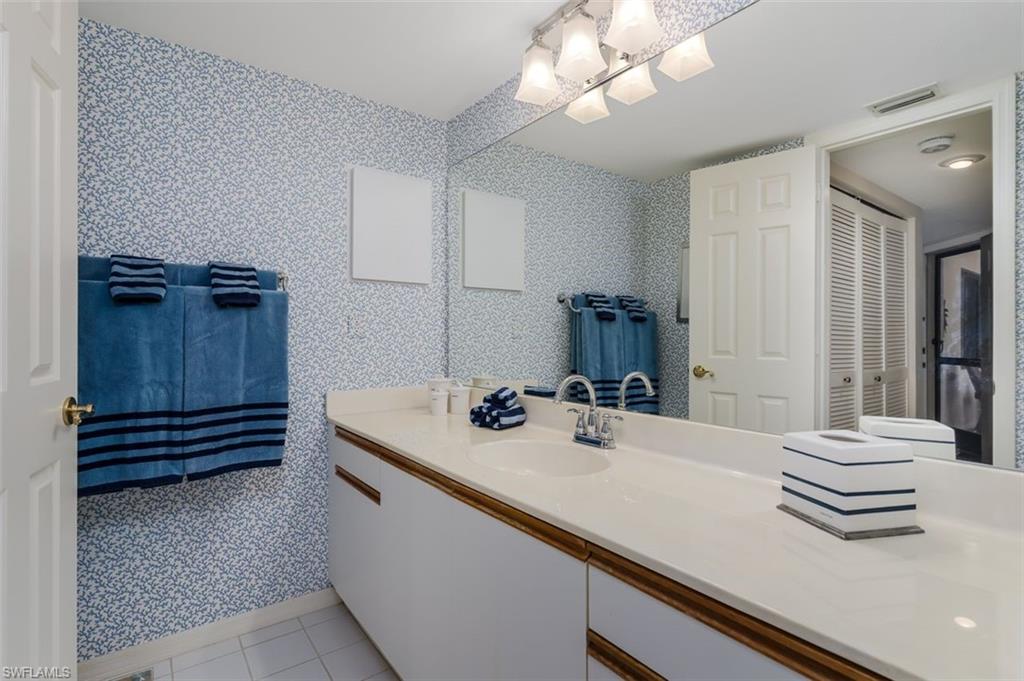 6545 Valen Way, Unit F205 Naples, FL 34108 - Photo 18 of 40 a bathroom with a sink and a mirror