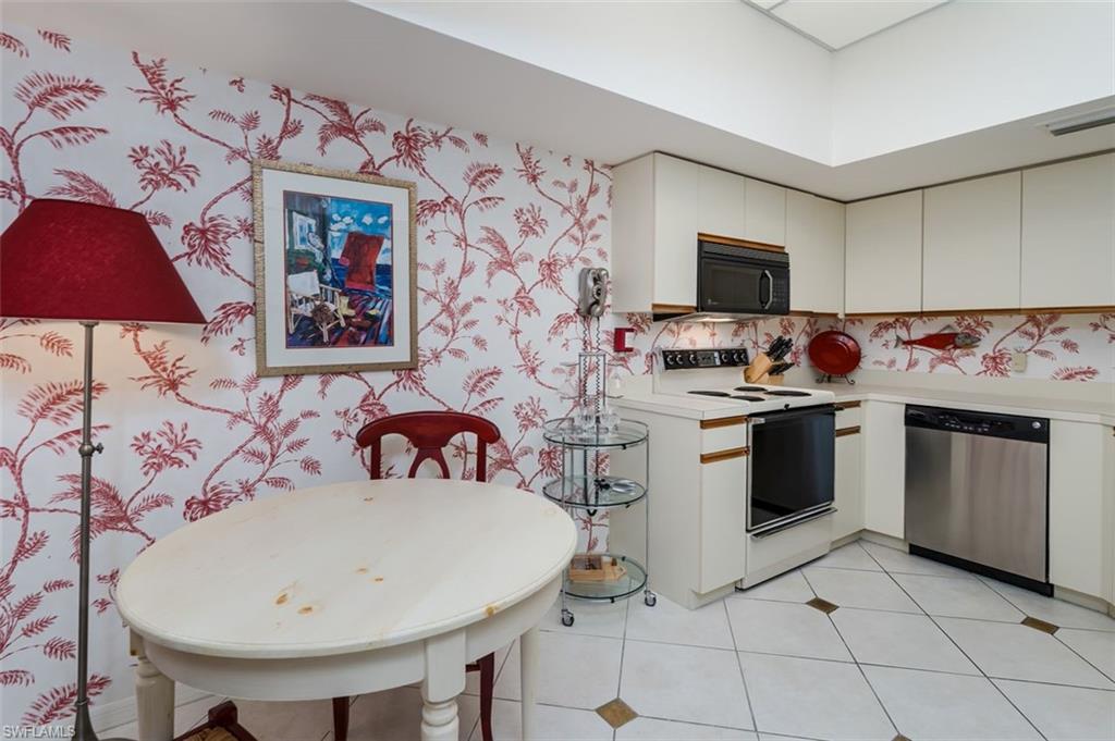 6545 Valen Way, Unit F205 Naples, FL 34108 - Photo 20 of 40 a kitchen with a sink a stove and cabinets