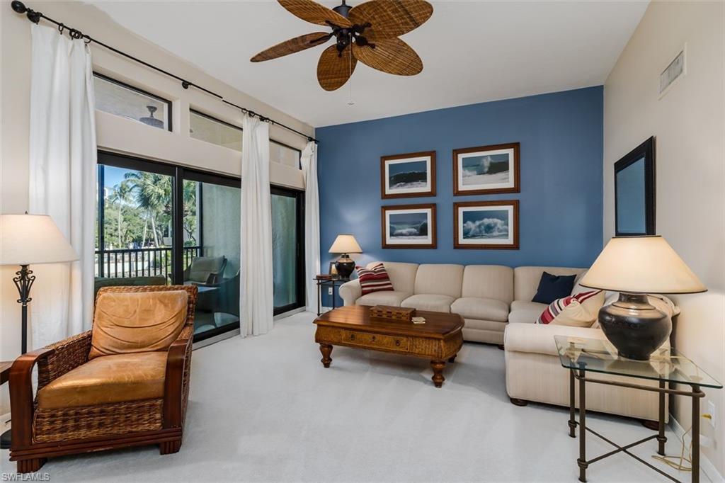 6545 Valen Way, Unit F205 Naples, FL 34108 - Photo 2 of 40 a living room with furniture and a large window