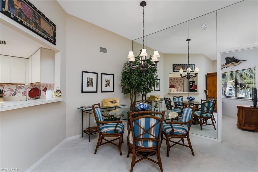 6545 Valen Way, Unit F205 Naples, FL 34108 - Photo 23 of 40 a view of a dining room with furniture