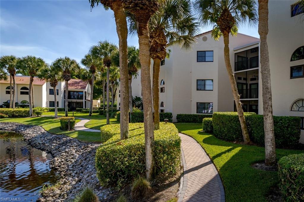 6545 Valen Way, Unit F205 Naples, FL 34108 - Photo 30 of 40 a front view of a house with a yard