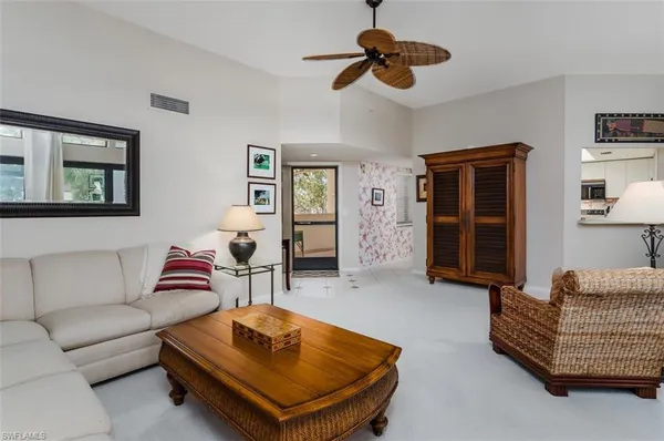 a living room with furniture and a ceiling fan