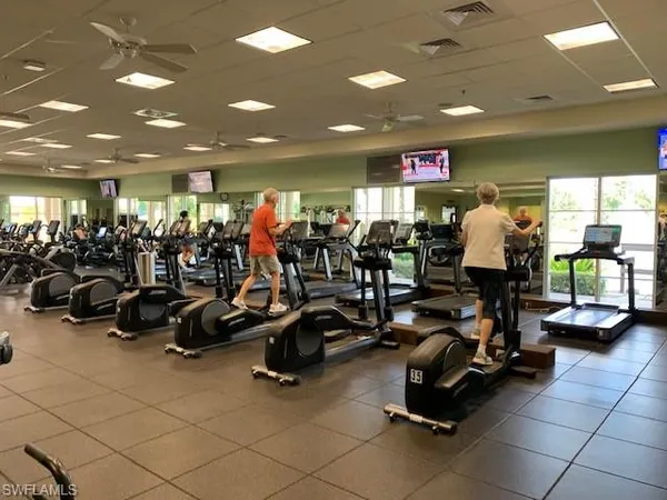 a living room with furniture and a gym machine