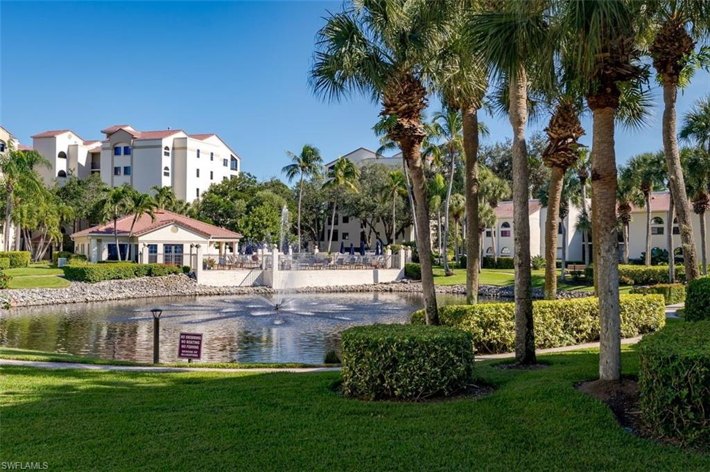 6545 Valen Way, Unit F205 Naples, FL 34108 - Photo 5 of 40 a front view of a house with a garden and swimming pool