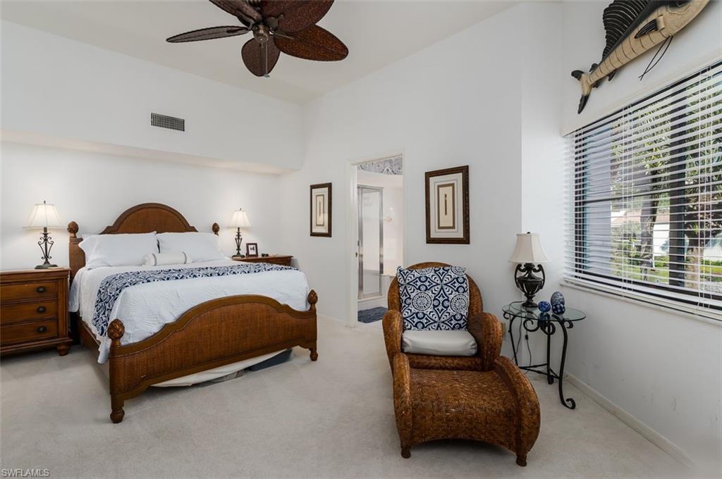 6545 Valen Way, Unit F205 Naples, FL 34108 - Photo 9 of 40 a bedroom with a bed couch and window