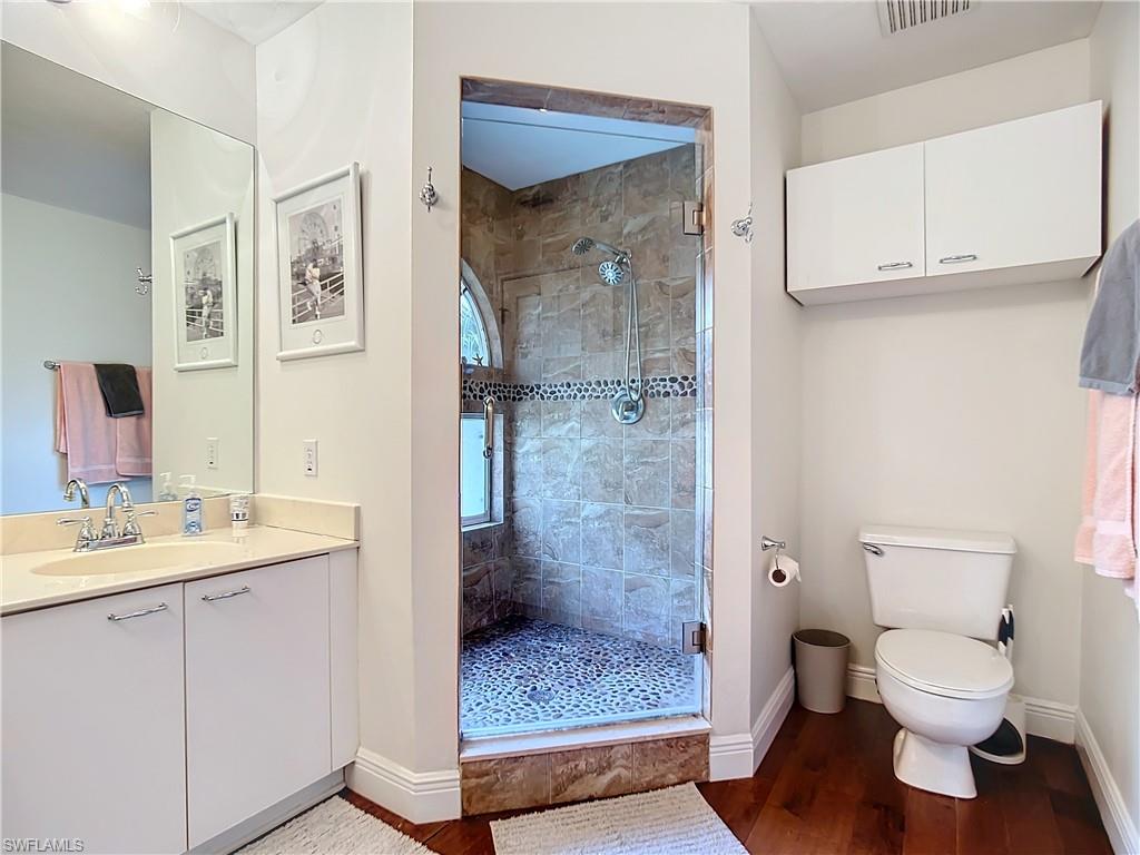 2860 Citrus Lake Drive, Unit R202 Naples, FL 34109 - Photo 39 of 50 a bathroom with a granite countertop sink toilet and shower