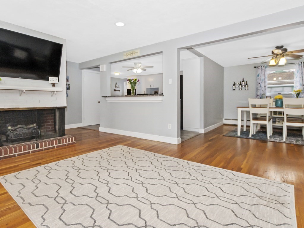 237 Linden Street Waltham, MA 02452 - Photo 11 of 33 a living room with a flat screen tv and a fireplace