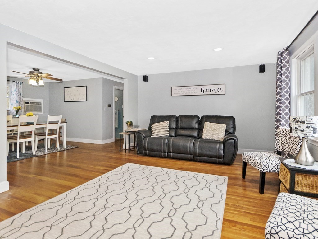 237 Linden Street Waltham, MA 02452 - Photo 13 of 33 a living room with furniture and a dining table with wooden floor