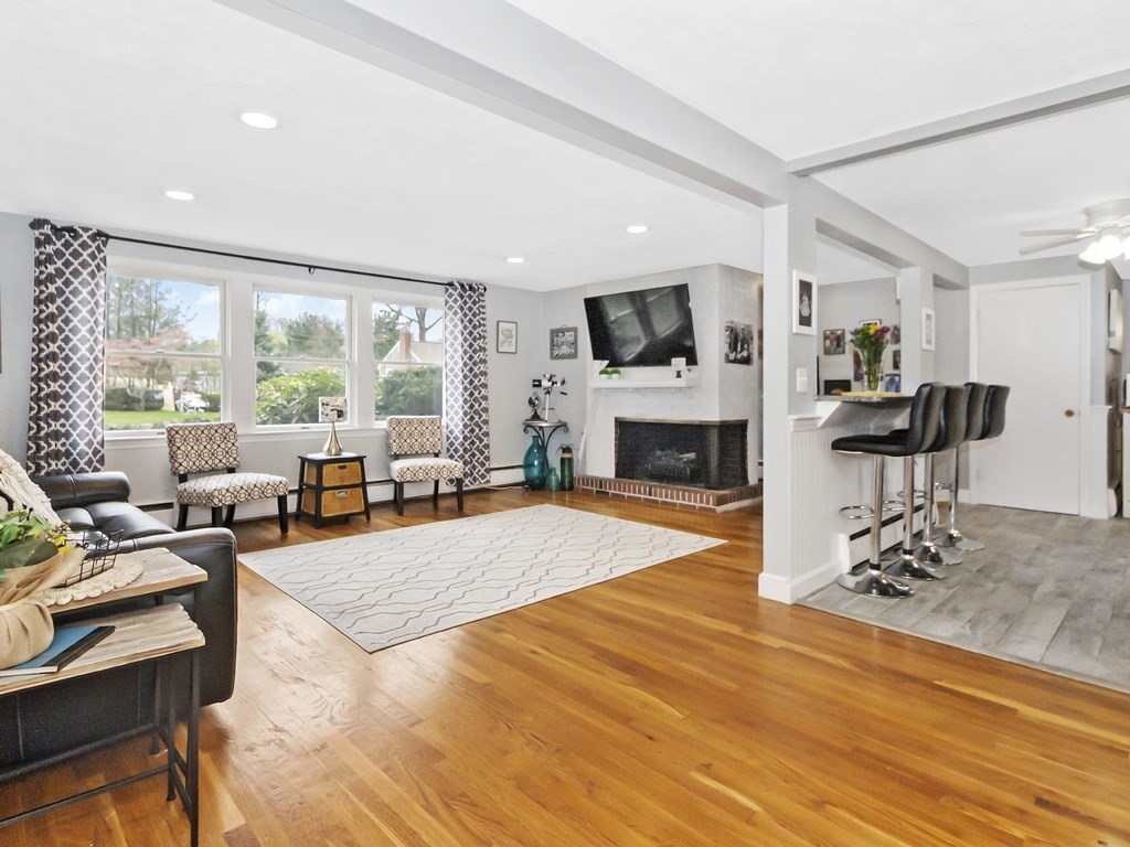 237 Linden Street Waltham, MA 02452 - Photo 14 of 33 a living room with furniture a fireplace and a flat screen tv