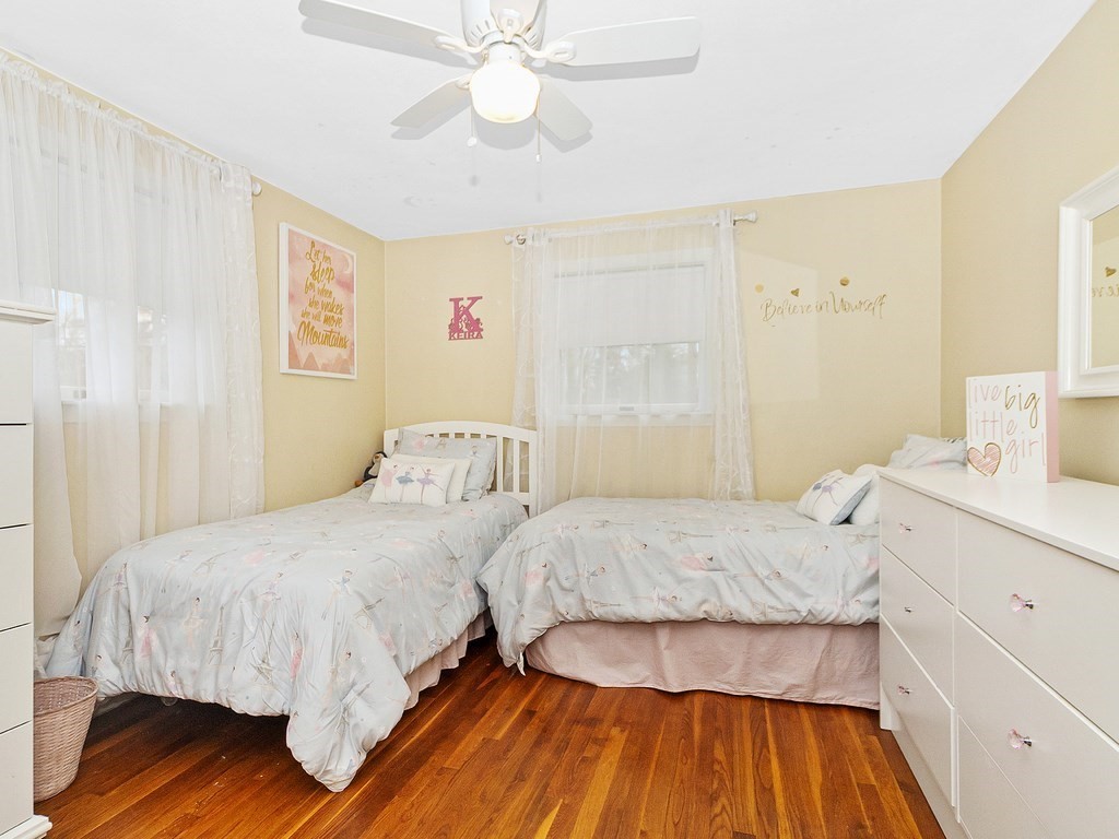 237 Linden Street Waltham, MA 02452 - Photo 22 of 33 a bedroom with a bed and wooden floor