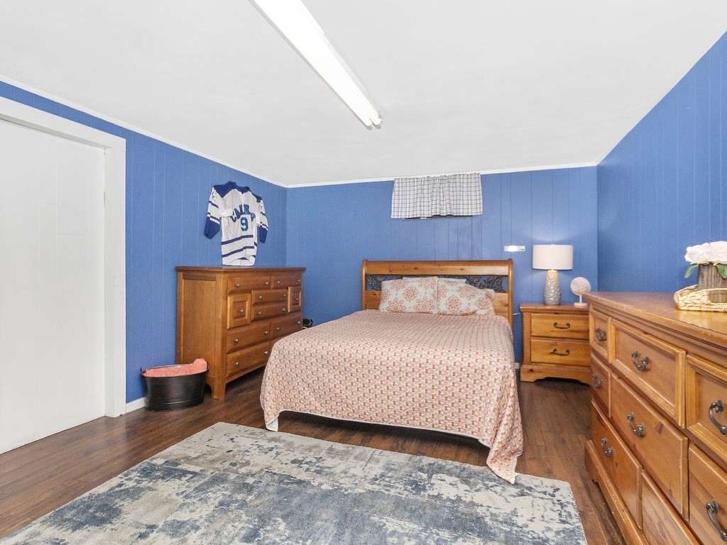 237 Linden Street Waltham, MA 02452 - Photo 23 of 33 a bedroom with a bed and wooden floor