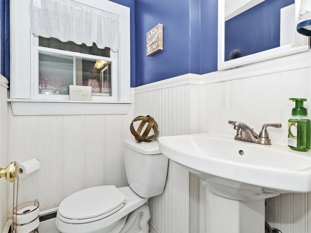 237 Linden Street Waltham, MA 02452 - Photo 28 of 33 a bathroom with a sink a toilet and mirror