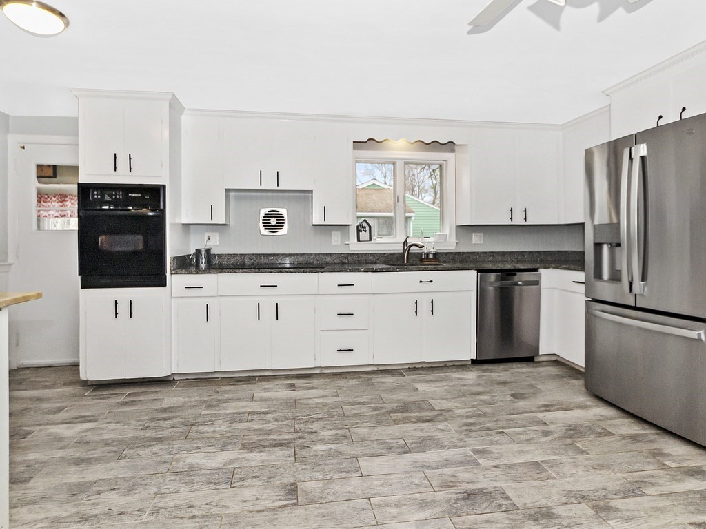 237 Linden Street Waltham, MA 02452 - Photo 3 of 33 a kitchen with stainless steel appliances granite countertop a stove a sink and a refrigerator