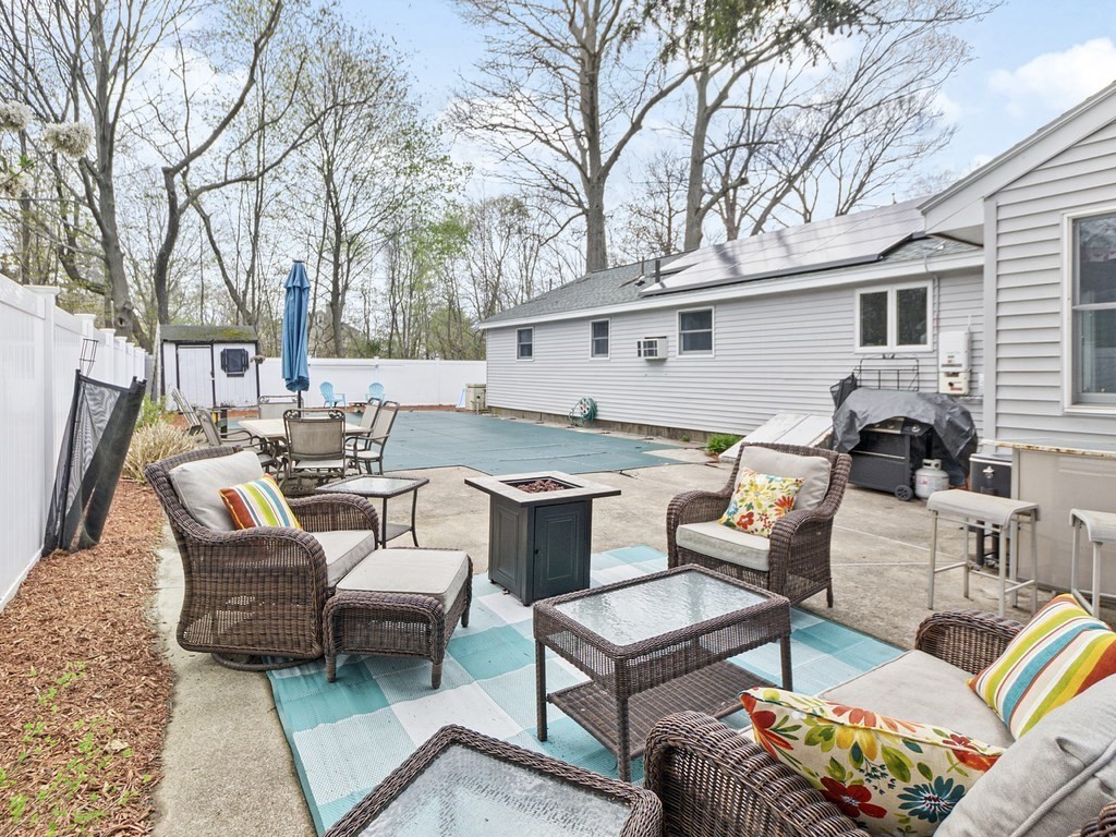 237 Linden Street Waltham, MA 02452 - Photo 32 of 33 a backyard of a house with barbeque oven table and chairs