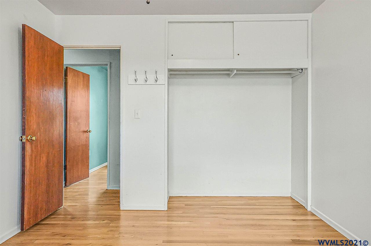 156 Northwest Reed Lane Dallas, OR 97338 - Photo 24 of 39 a view of an empty room with wooden floor