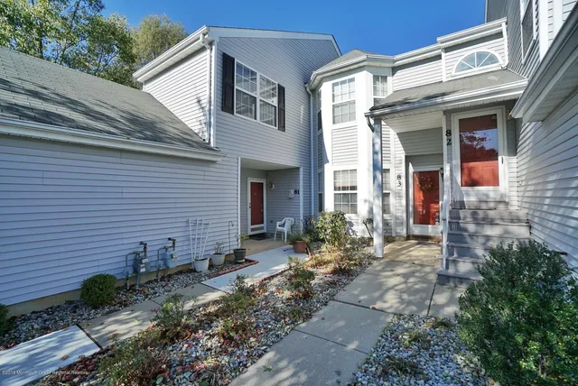 a view of a house with chairs and flower plants
