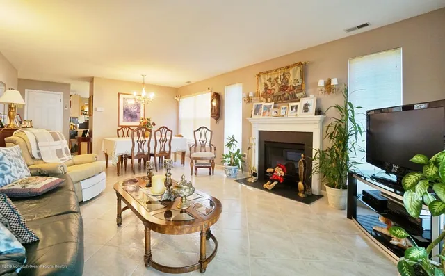a living room with furniture a flat screen tv and a fireplace